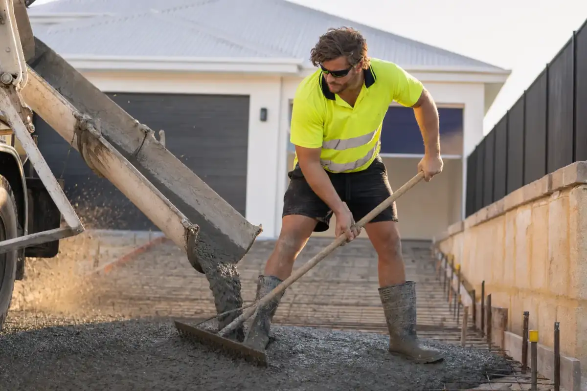 Concrete pour in progress from truck chute on a Perth residential slab site